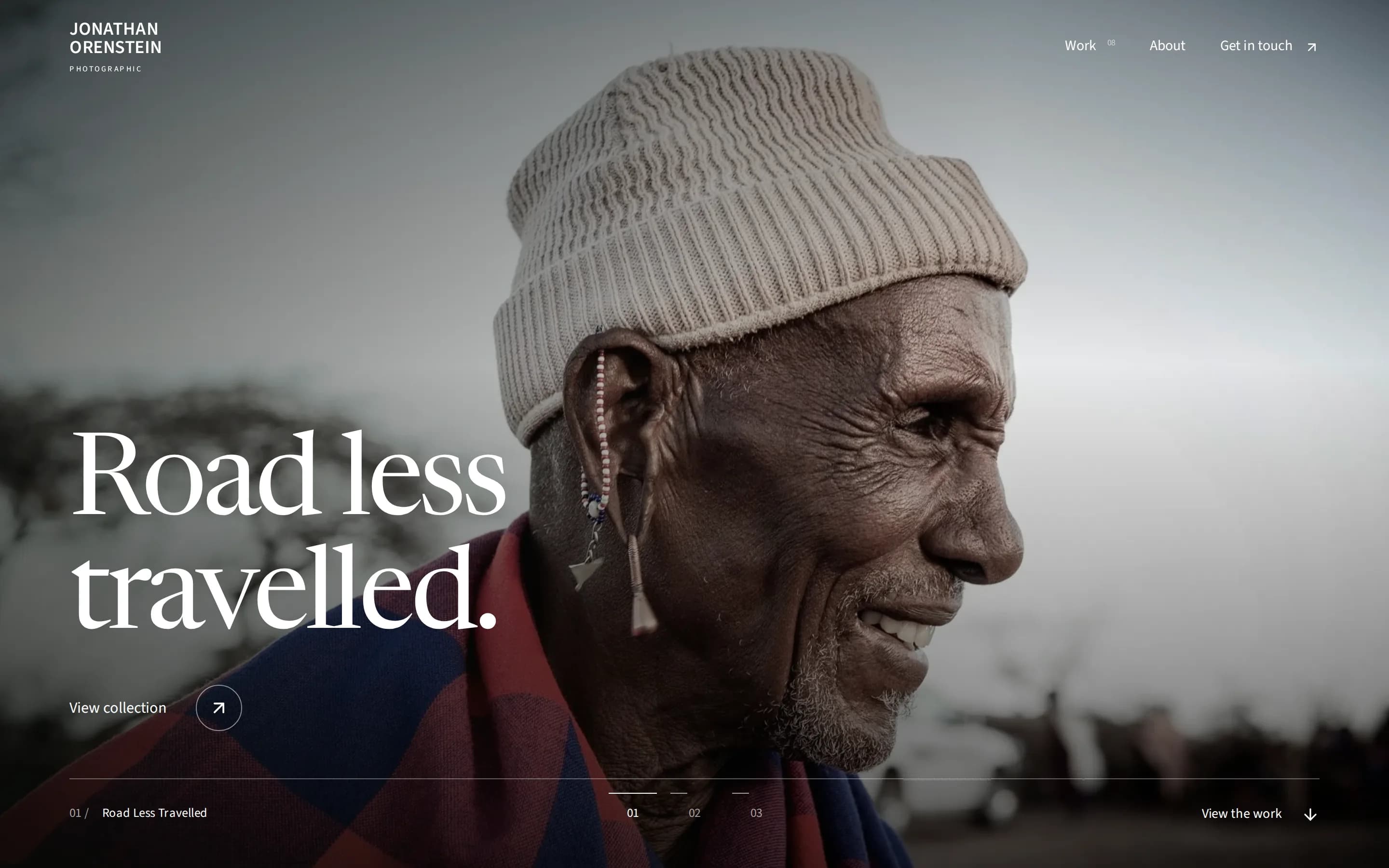 Jonathan Orenstein Photographic home page: a full-screen portrait of an older man in a knit cap under the headline Road less travelled, with View collection and controls for three opening photographs